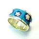 Silver jewel with turquoise gemstone and flowers