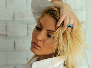 Jewelry model wearing stylish ring with turquoise and charoite